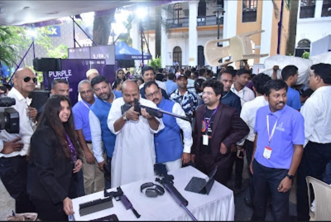 Dr. Virendra Kumar, Hon'ble Union Minister of Social Justice and Empowerment while trying out Fundook game at the Purple Fest.